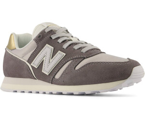 New balance black & gold hotsell 373 suede & mesh trainers